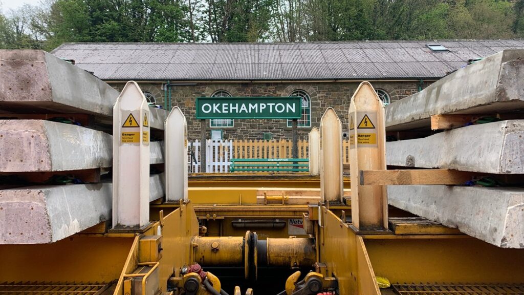 Okehampton station sign visible between sleepers