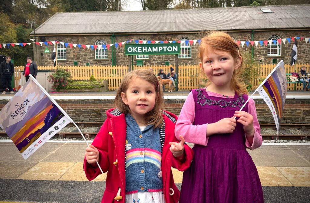 Children waving flags at Okehampton station