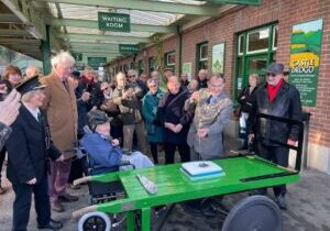 Okehampton Mayor Cllr Allenton Fisher cuts the birthday cake with his ceremonial naval sword